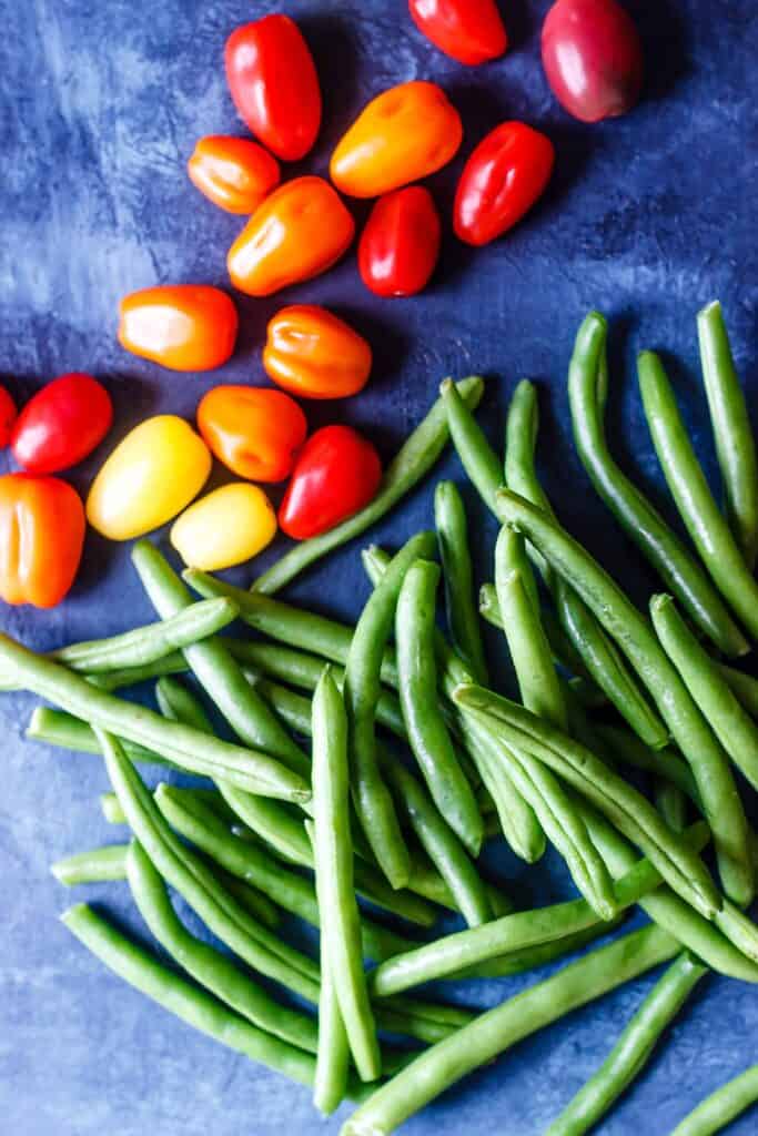 Green Beans and Cherry Tomatoes on a blue background
