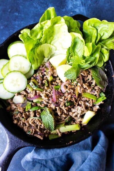 Keto Larb in a cast iron skillet on a blue background
