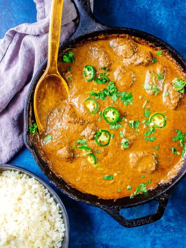 Keto Butter Chicken in a cast iron skillet with cauliflower rice