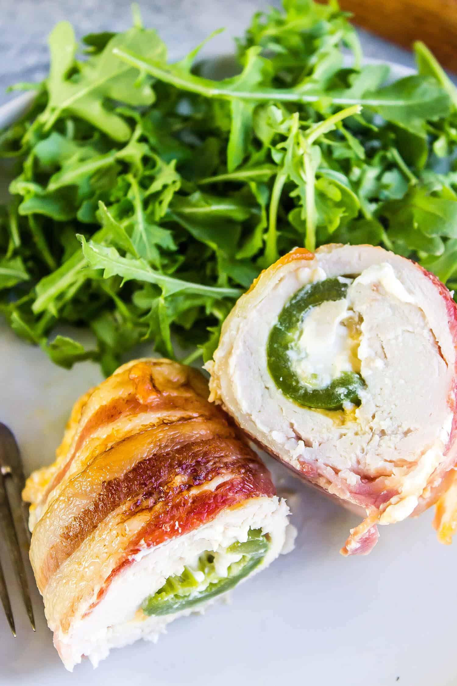cooked Jalapeno Popper Chicken on plate with arugula