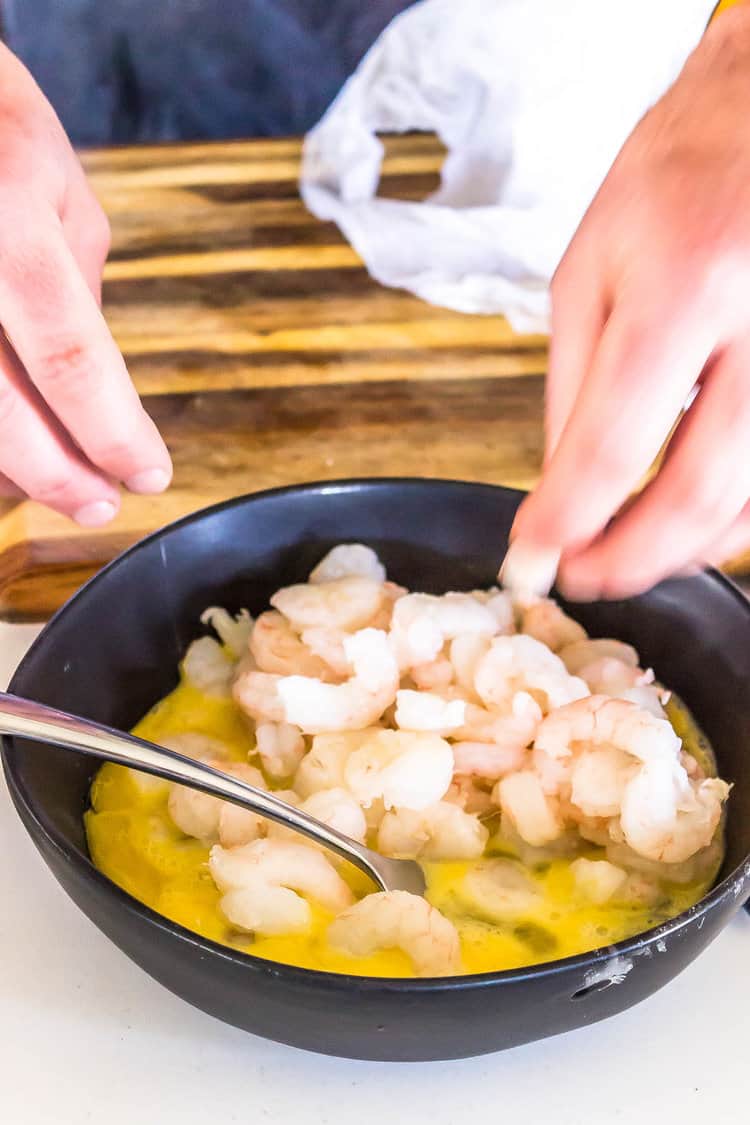 shrimp being dipped into an egg wash