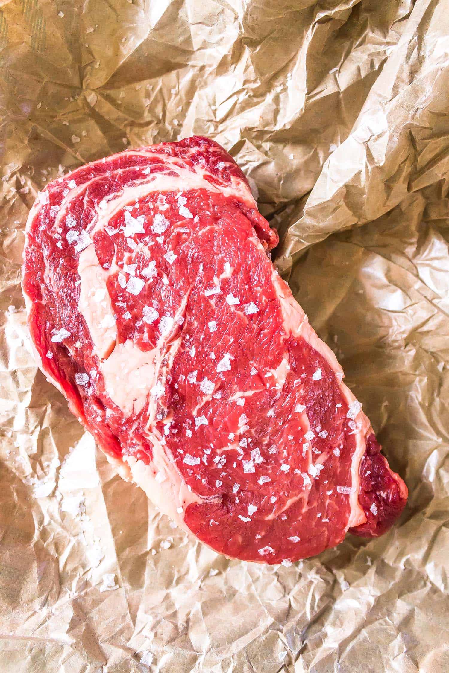 raw steak on a sheet of butcher paper
