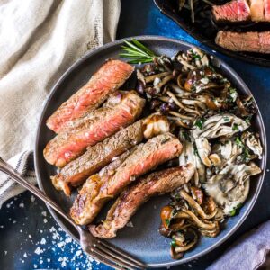 Cast Iron Steak on a plate with Garlic Butter Mushrooms