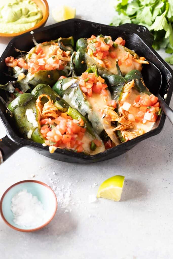 Peppers in skillet stuffed with chicken cheese and pico de gallo