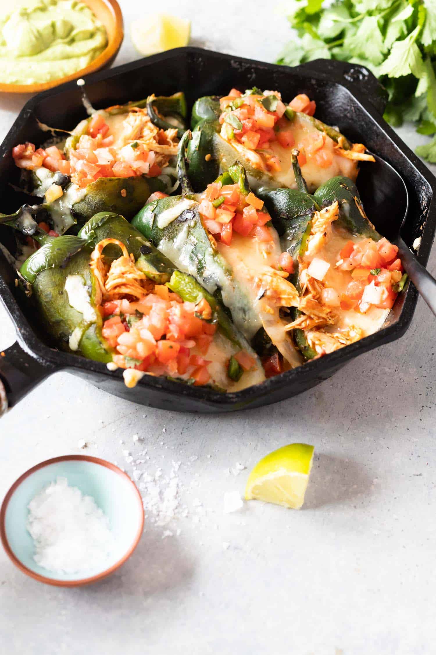 Peppers in skillet stuffed with chicken cheese and pico de gallo