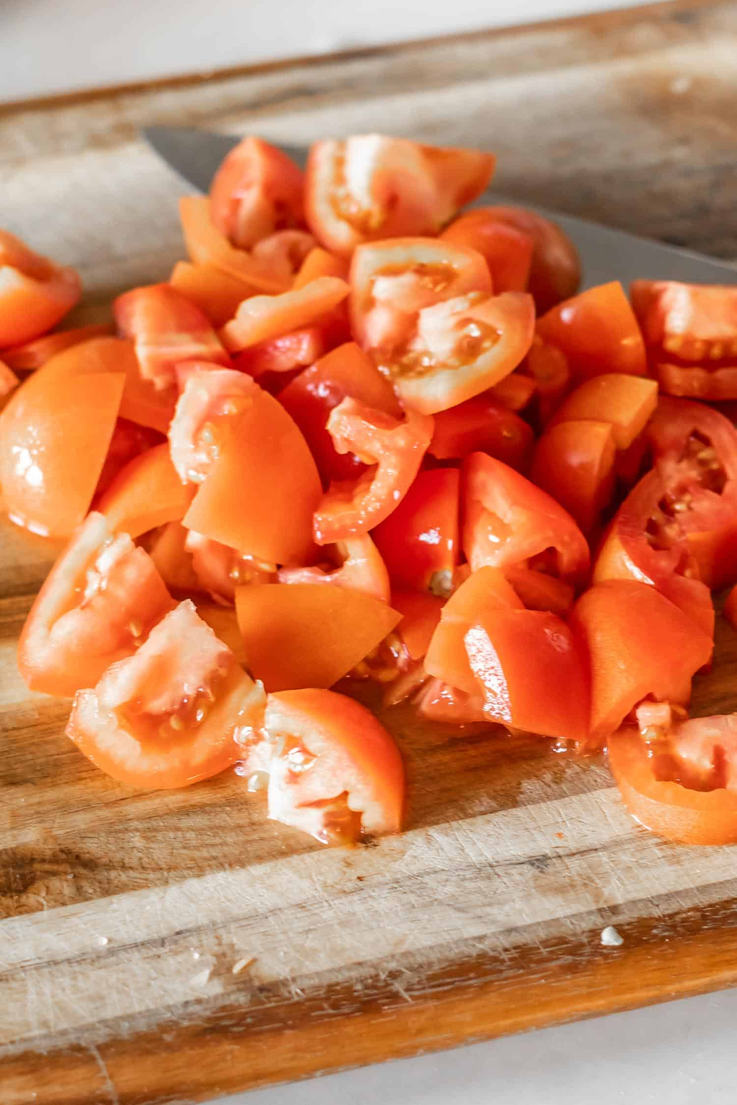 chopped tomatoes on cutting board