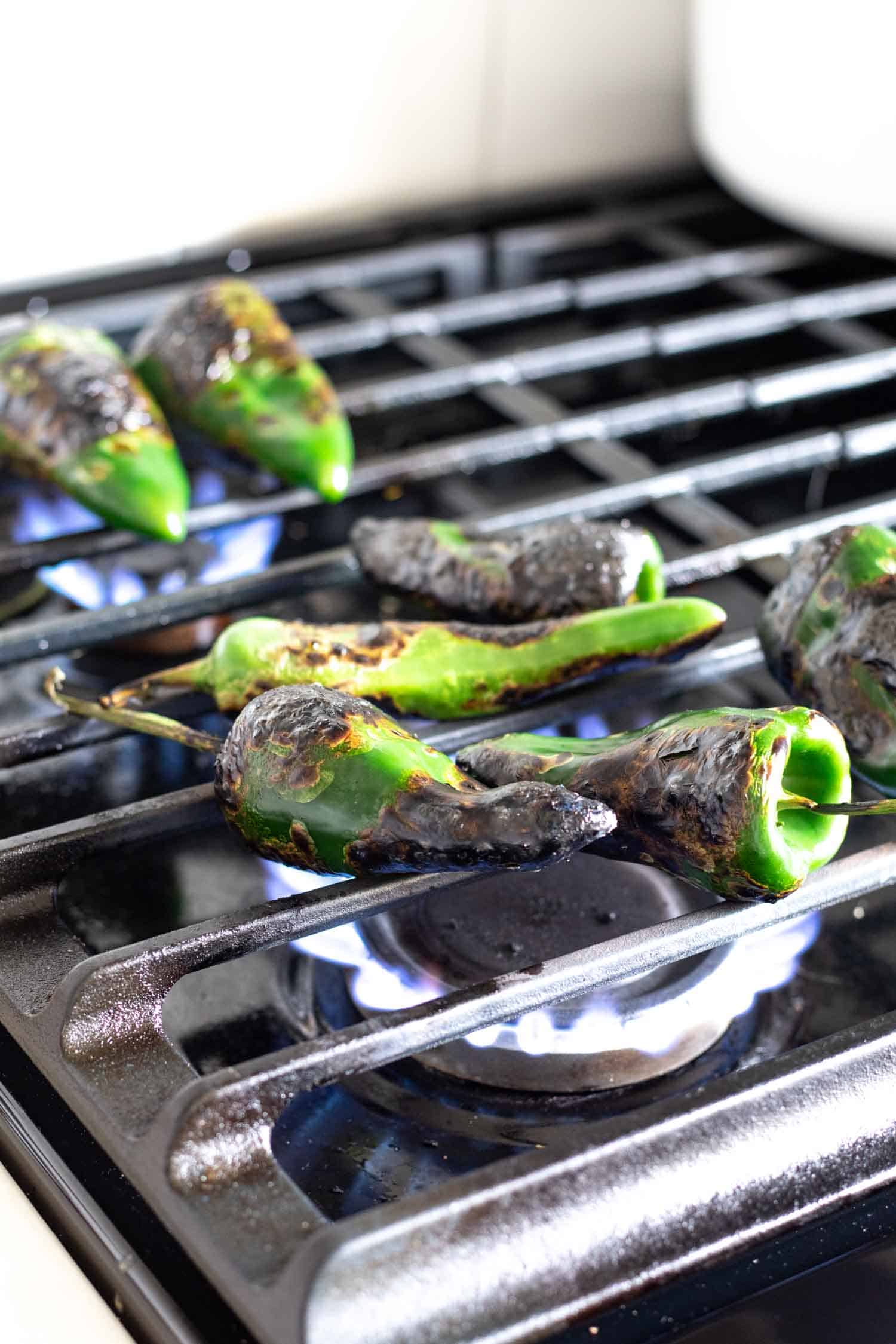 roasting poblano peppers over a gas flame