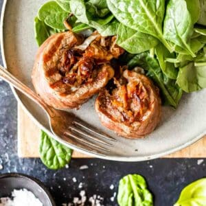 Keto Steak Roll-Ups on plate with spinach