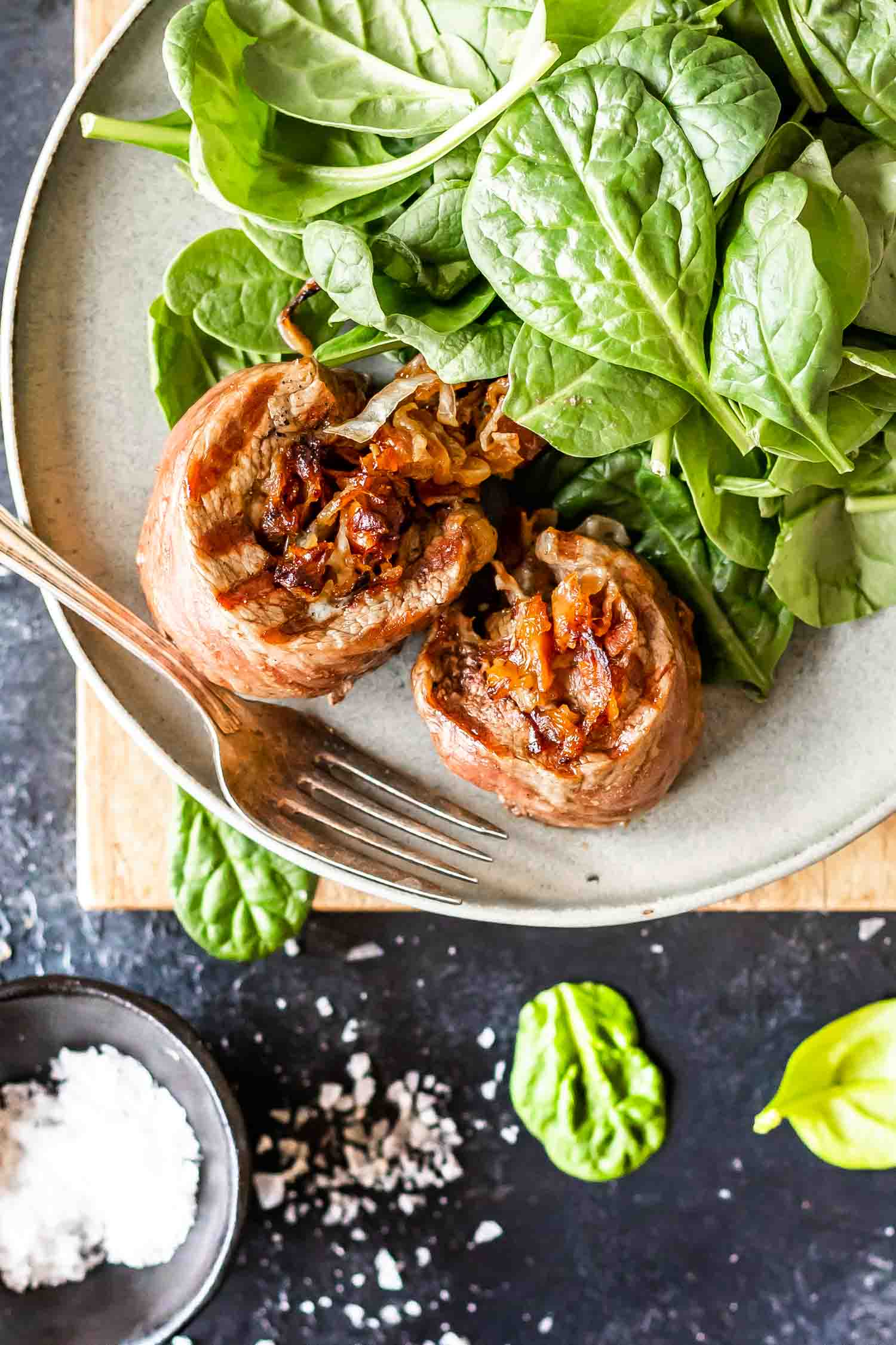 Keto Steak Roll-Ups on plate with spinach