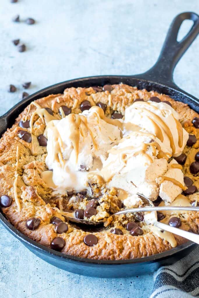 Keto Chocolate Chip Peanut Butter Skillet Cookie served with keto friendly ice cream on top