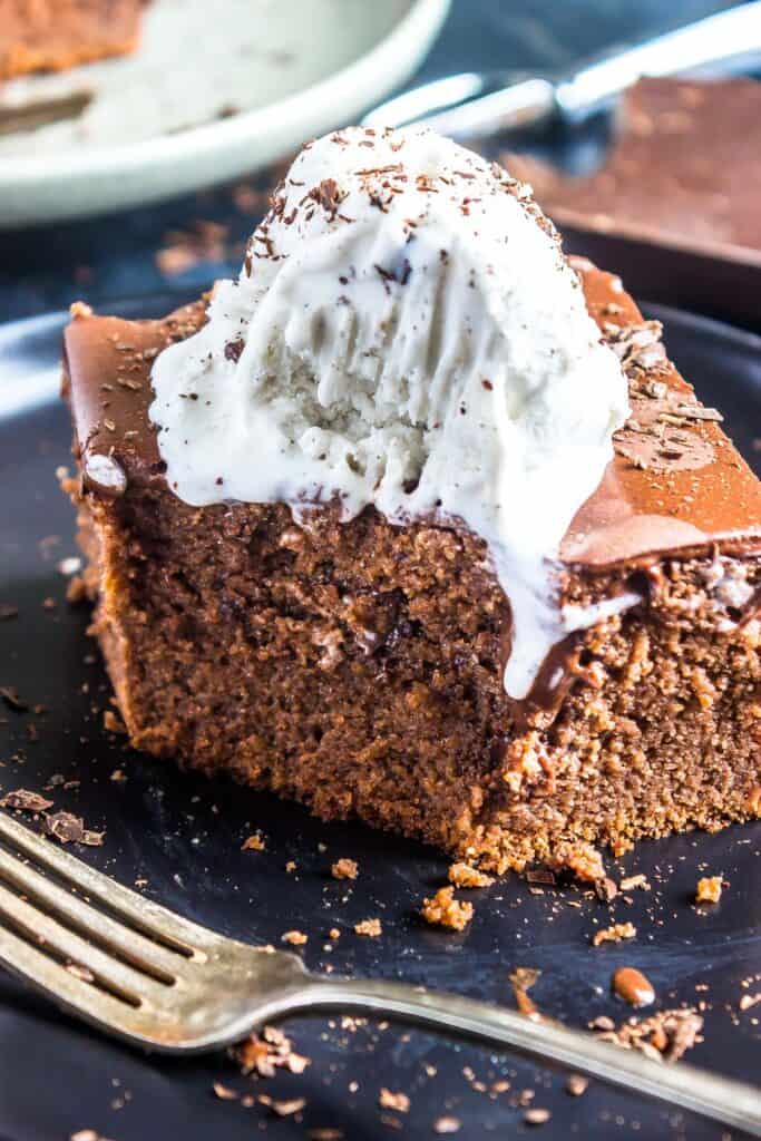 Keto Chocolate Pudding Poke Cake with a bite taken out