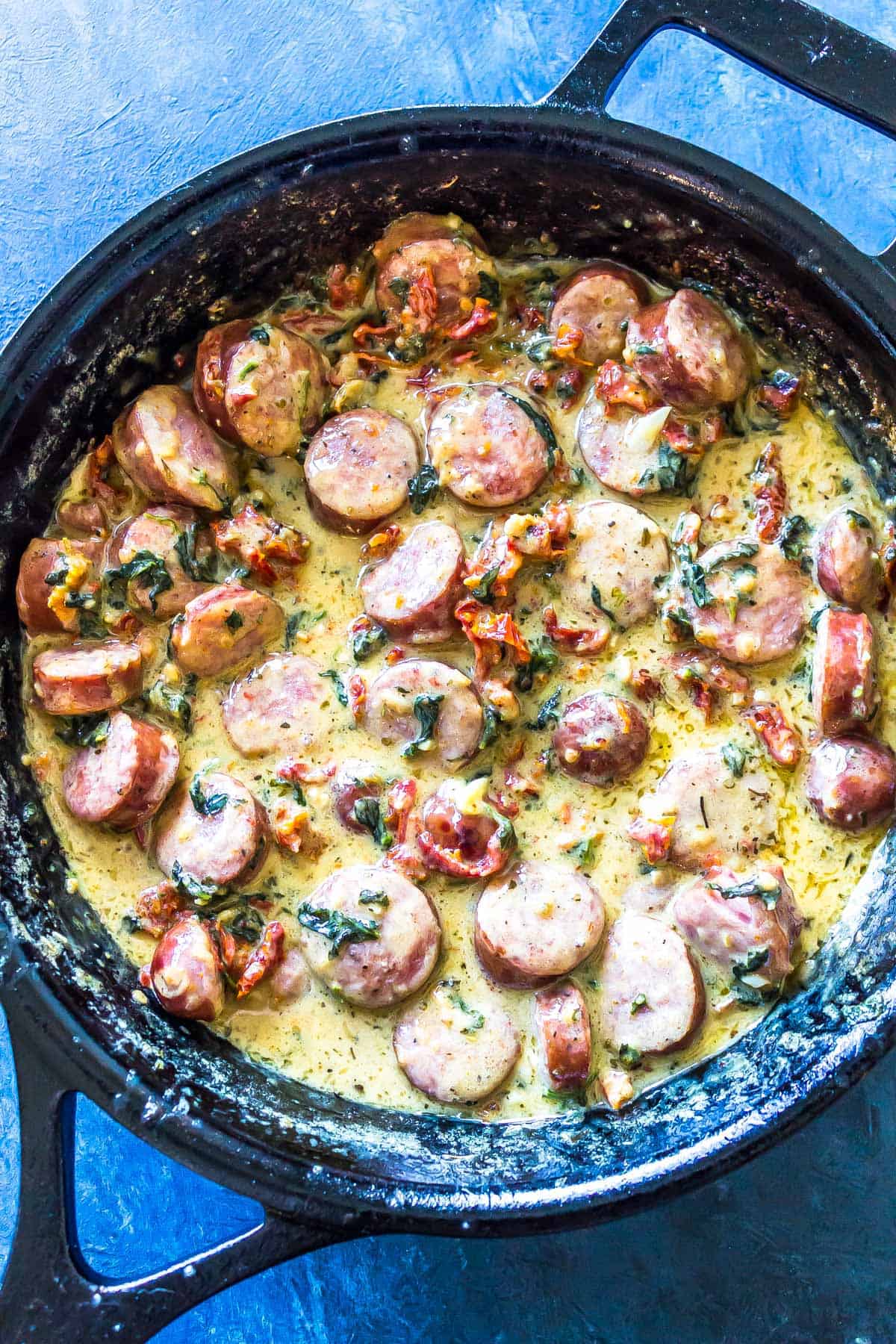 Sausage an creamy sauce in a cast iron skillet