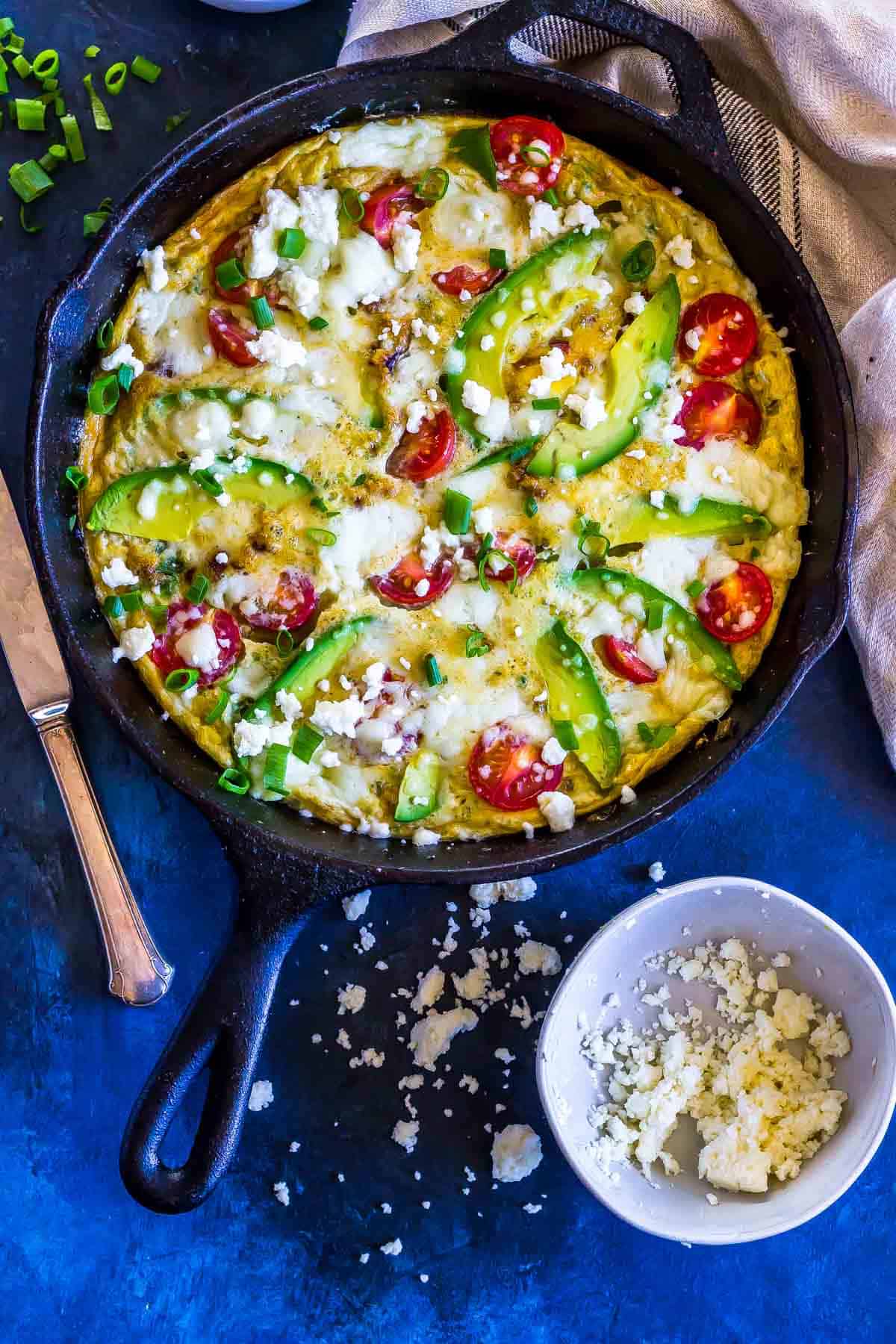 Keto Frittata with Avocado and Queso in a cast iron skillet