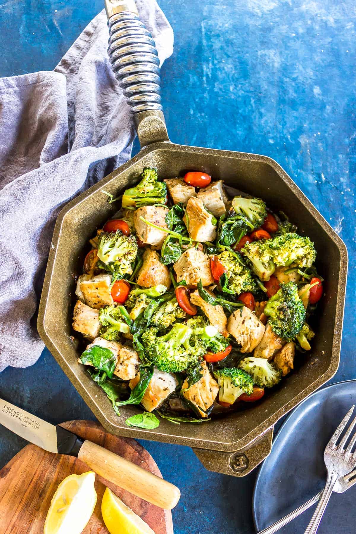 Keto Italian Chicken Skillet (cubed chicken, broccoli, cherry tomatoes and sauce) in a finex cast iron skillet.
