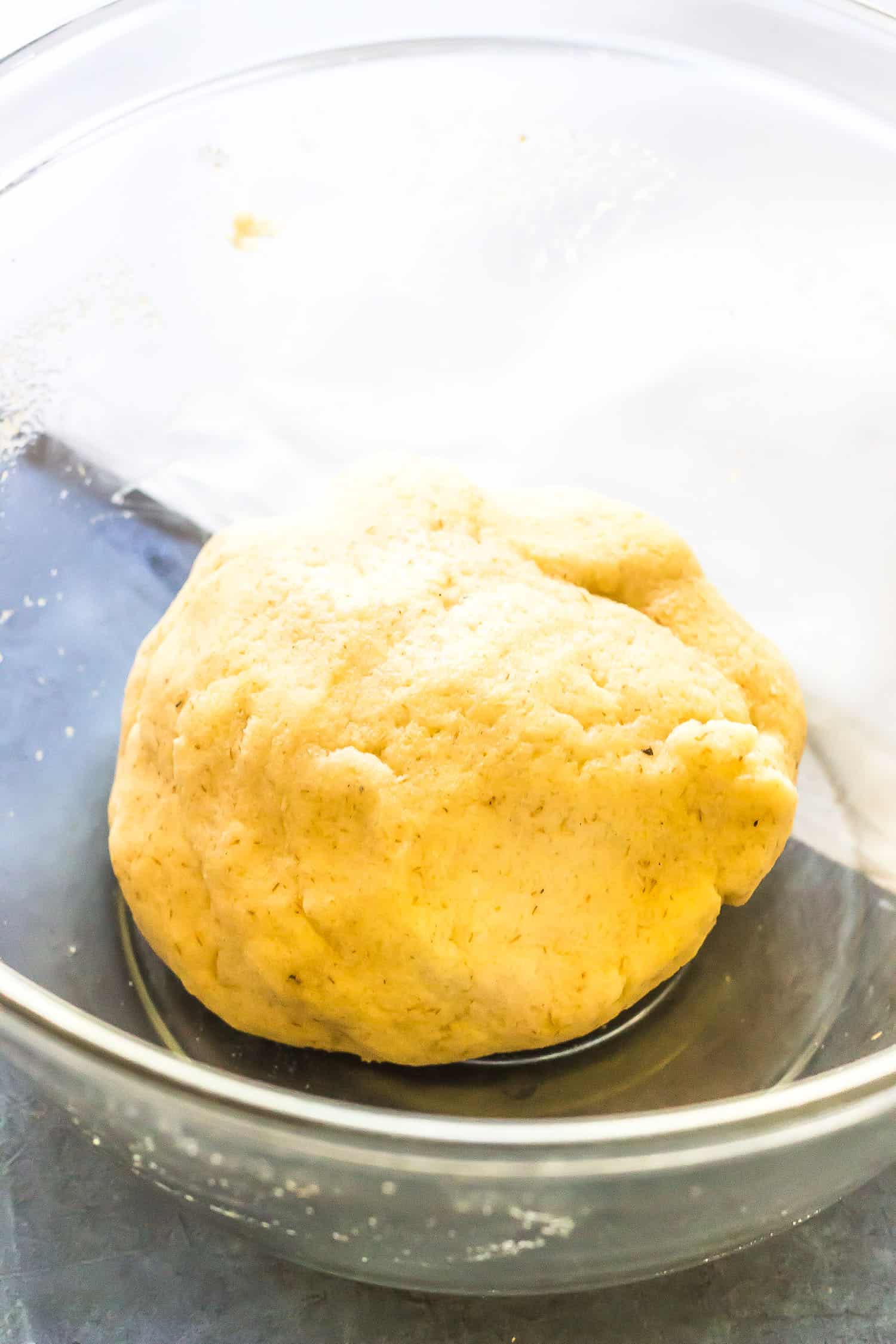 Keto Naan dough mixed up into a ball in a glass bowl