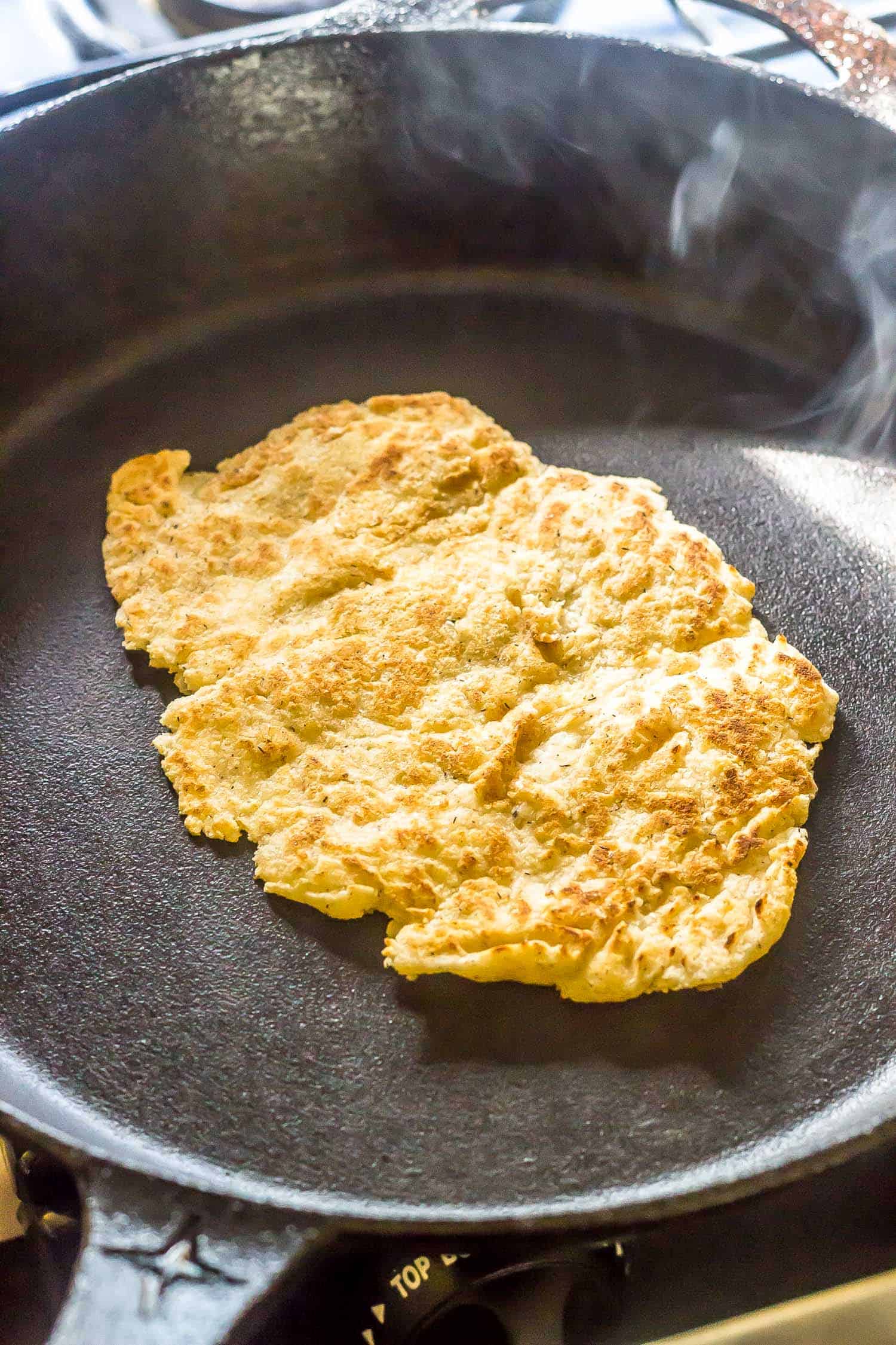 frying the naan in a cast iron skillet