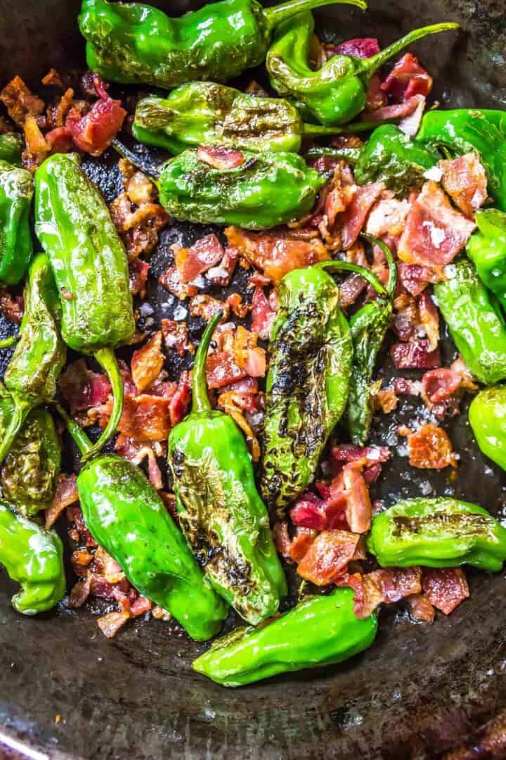 Keto Shishito Peppers in a skillet with bacon