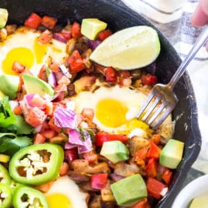 Keto Southwestern Breakfast Hash with a fork taking a bite out of a runny egg