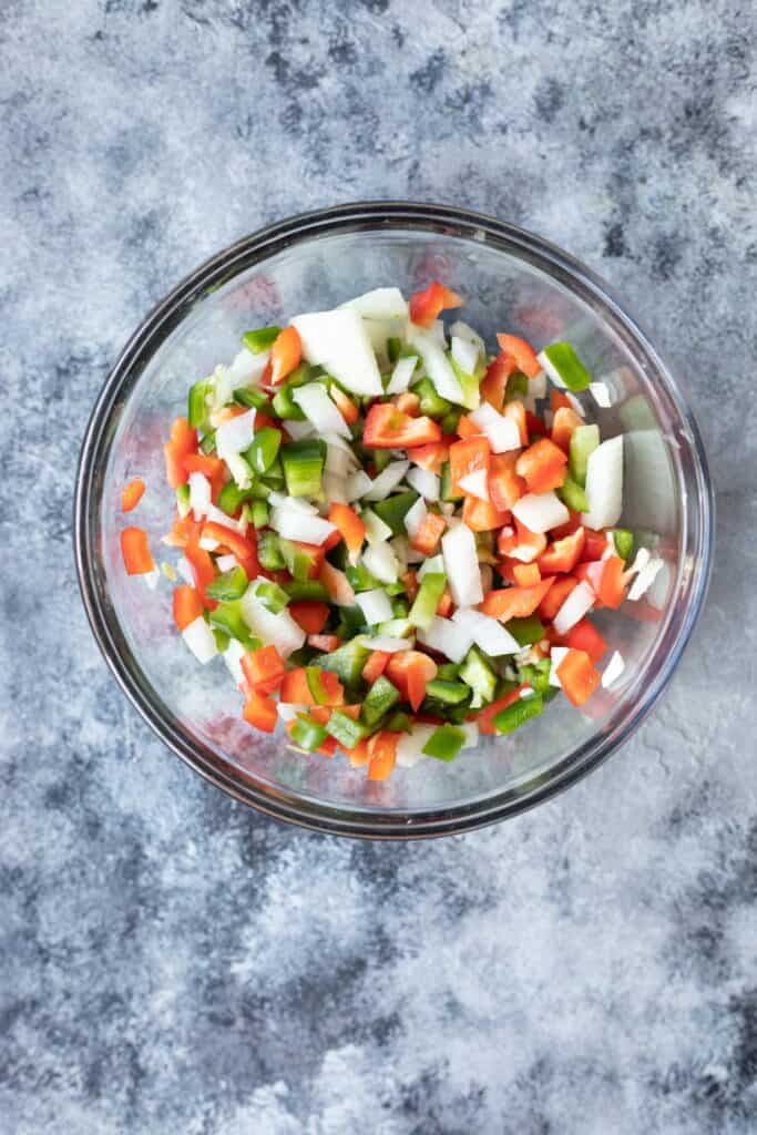 Glass bowl filled with a mixture of raw vegetables