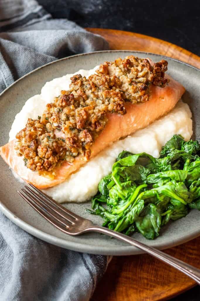 Pecan and Gouda Crusted Salmon on plate with spinach and cauli mash