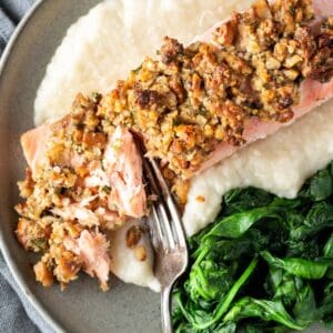 Pecan and Gouda Crusted Salmon on plate with spinach and cauli mash