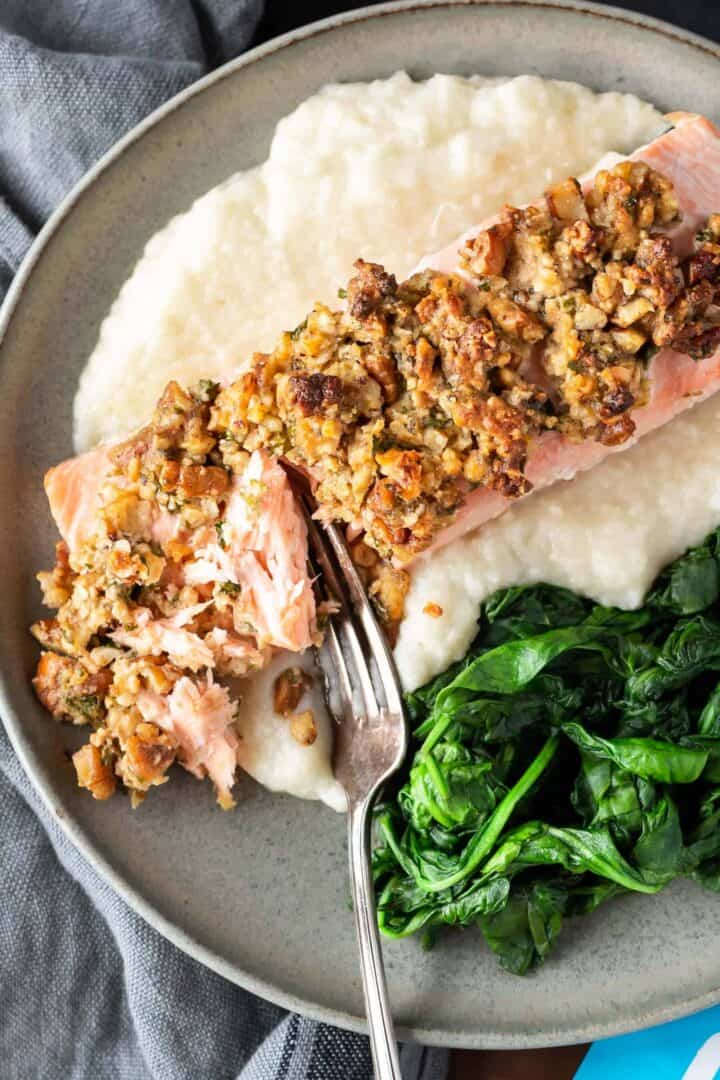 Pecan and Gouda Crusted Salmon on plate with spinach and cauli mash