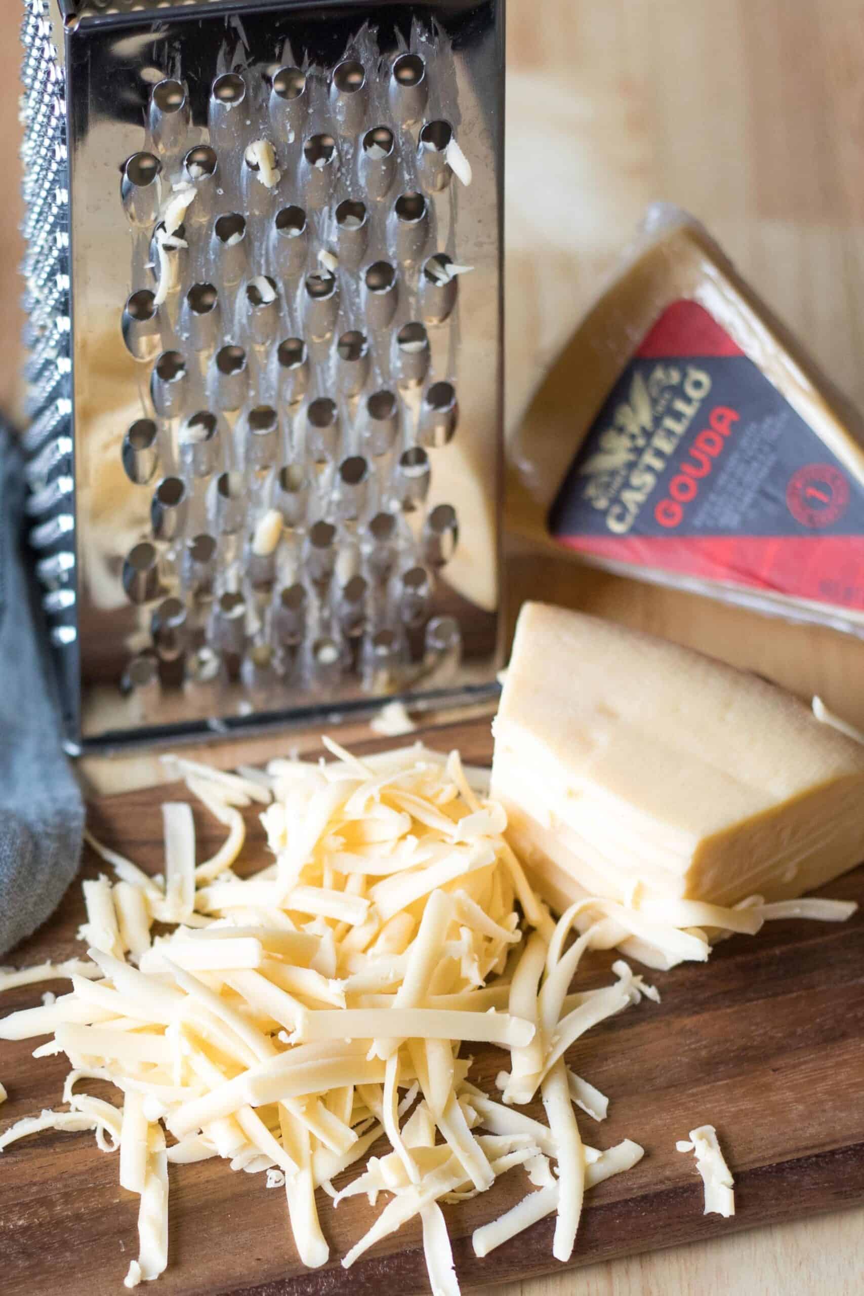 close up of gouda next to a cheese grater