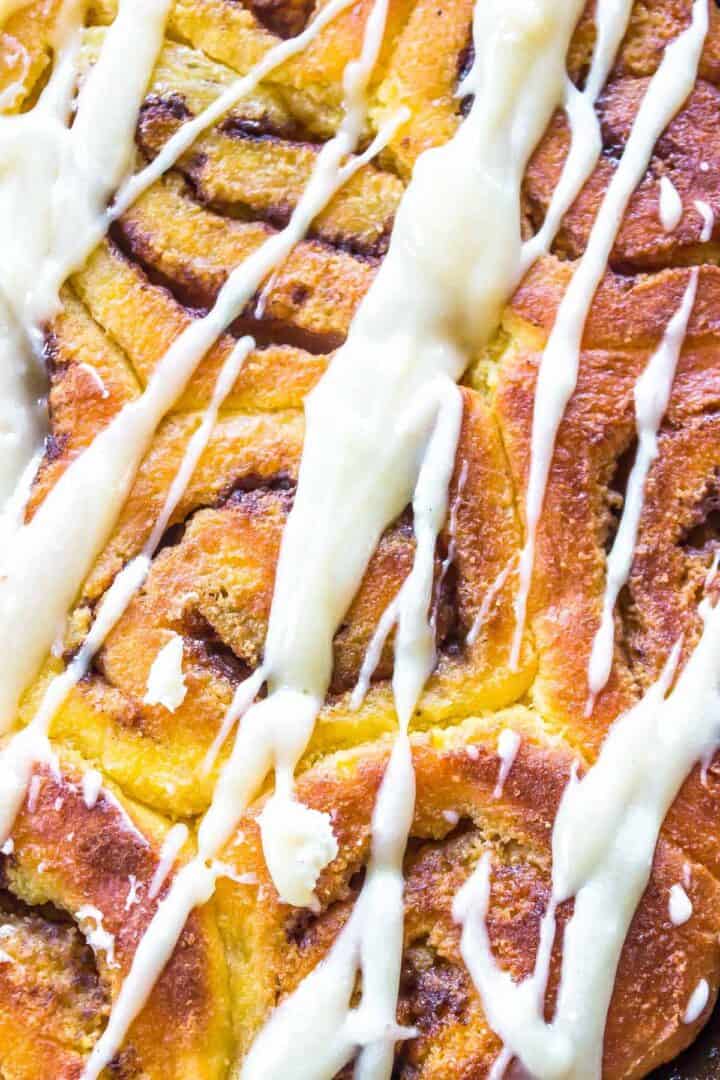Keto Cinnamon Rolls closeup with cream cheese drizzle