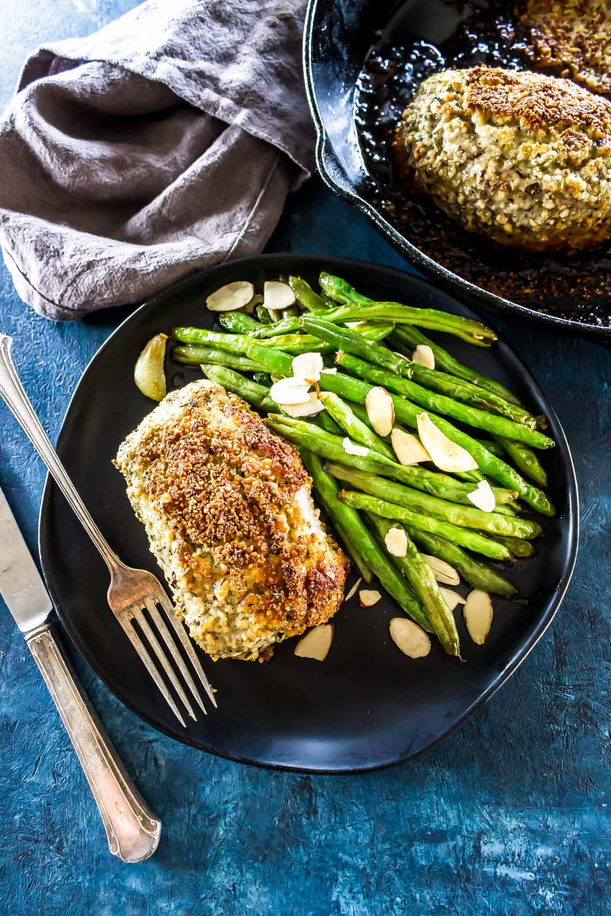 Keto Parmesan Crusted Pork Chops served with green beans almondine.