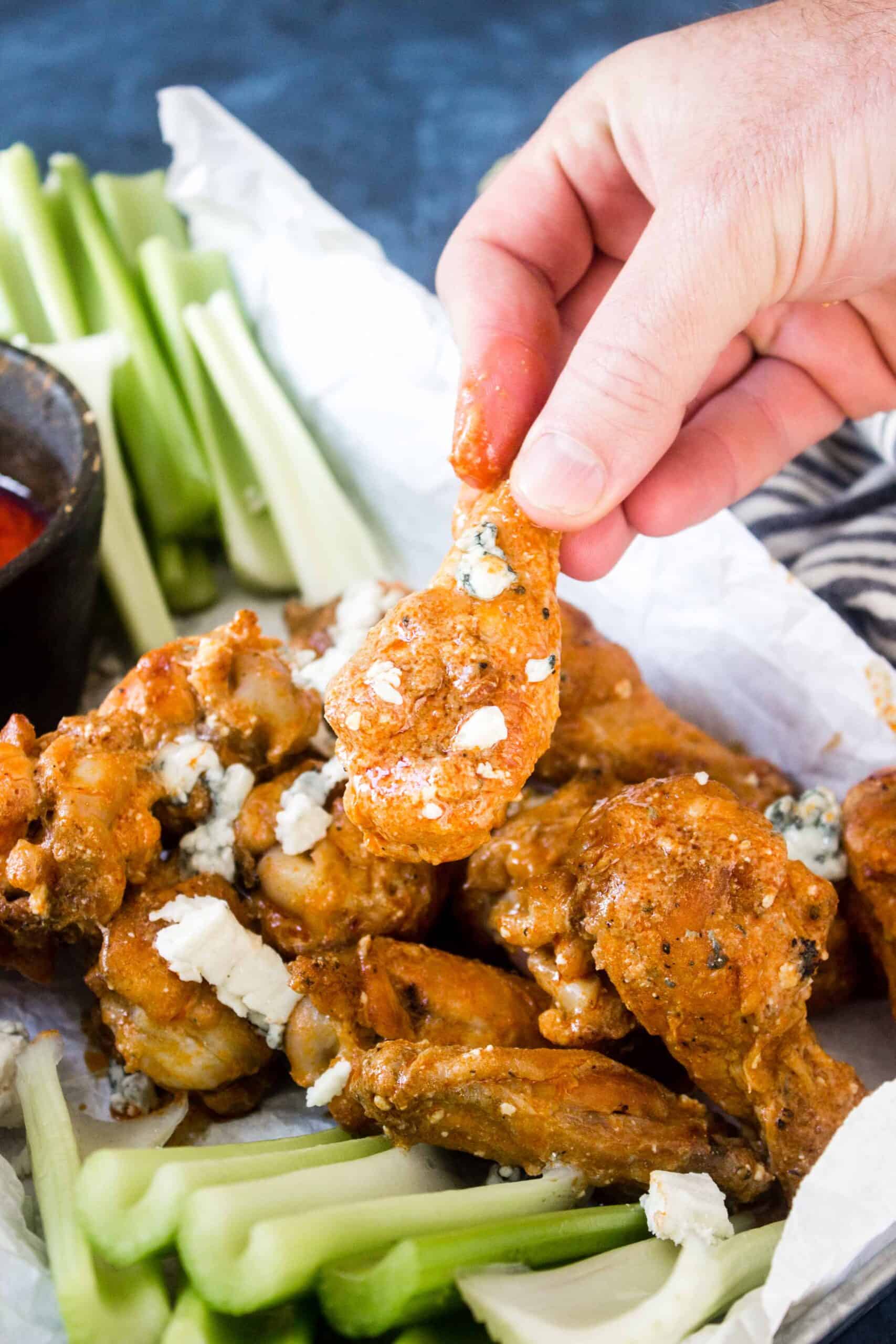 keto chicken wings in tray with buffalo blue cheese sauce and celery