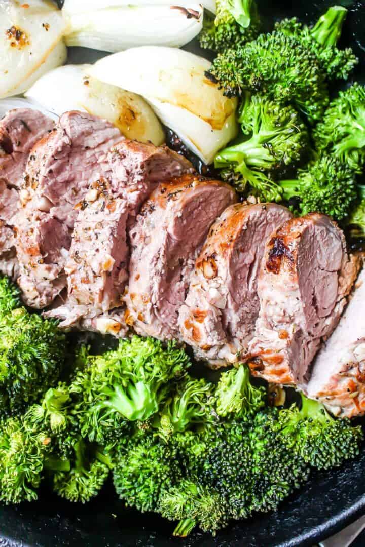 Keto Pork Tenderloin Skillet Dinner. Pork tenderloing, broccoli, and onions in a skillet.