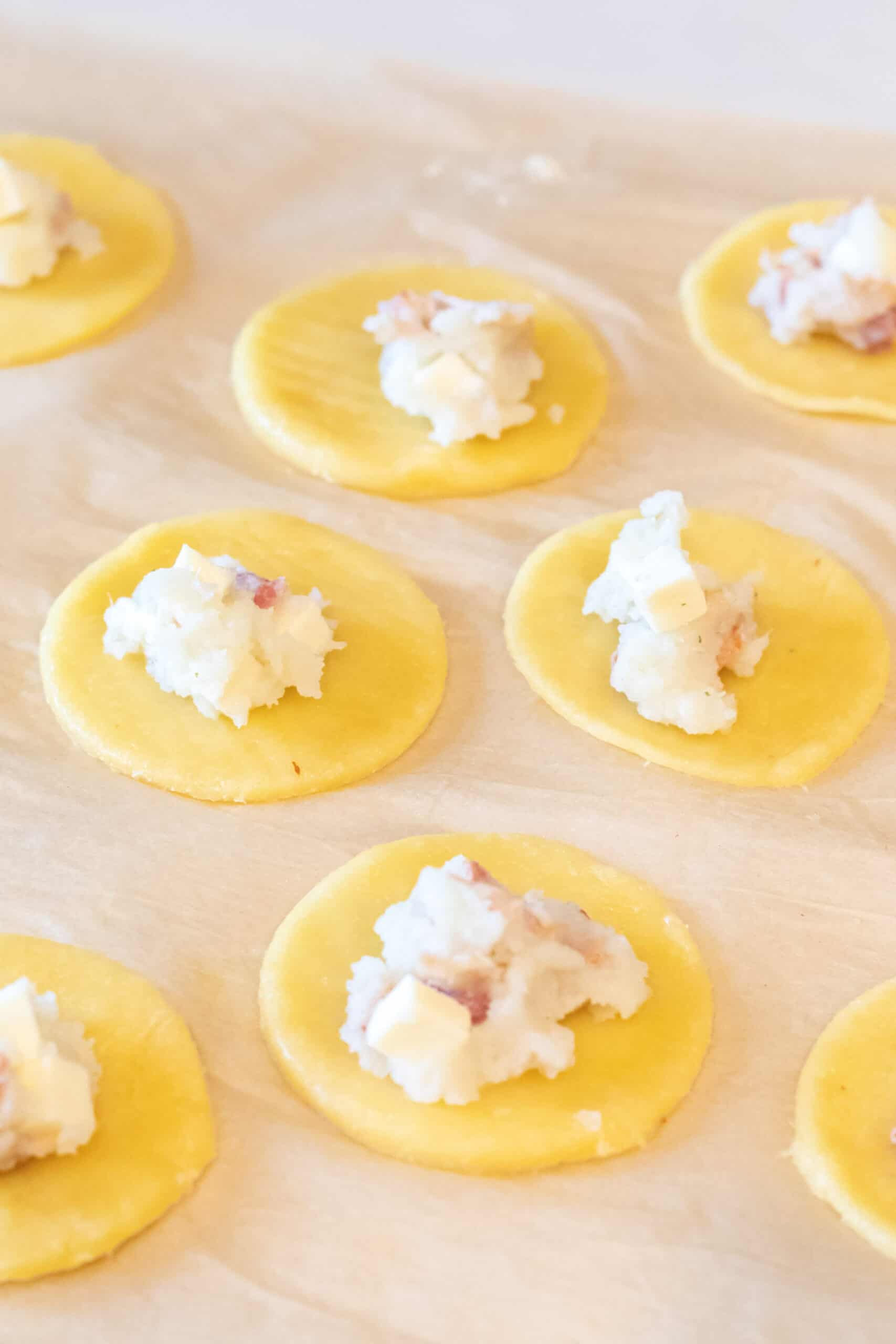 Raw Pierogi dough with filling spooned into the center.