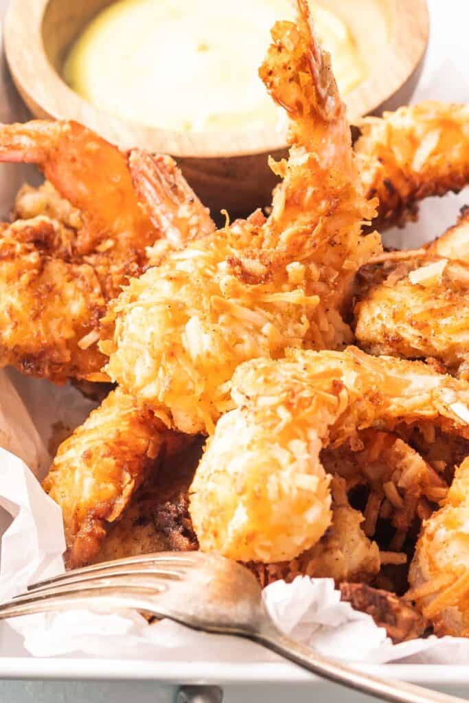 a close-up shot of coconut shrimp in a serving tray