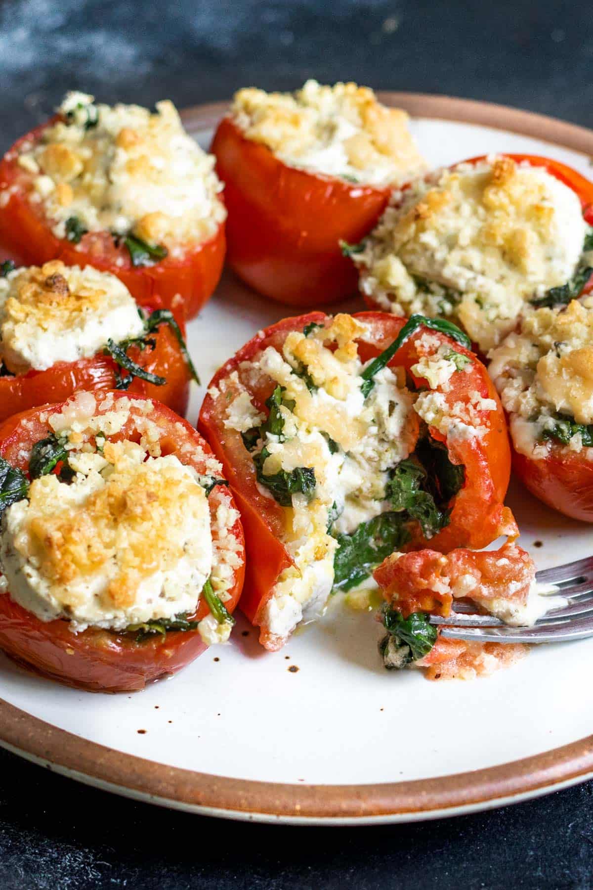 Tomatoes hollowed out and stuffed with wilted spinach, herbed goat cheese, parmesan, and Moon Cheese.