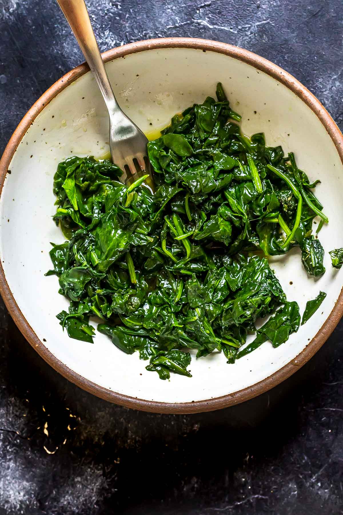 wilted spinach in a ceramic bowl