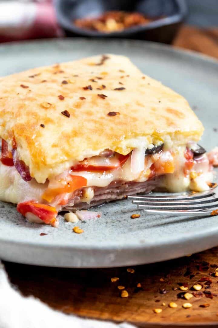 Keto Italian Sub Sandwich Casserole on a grey plate with a fork in front