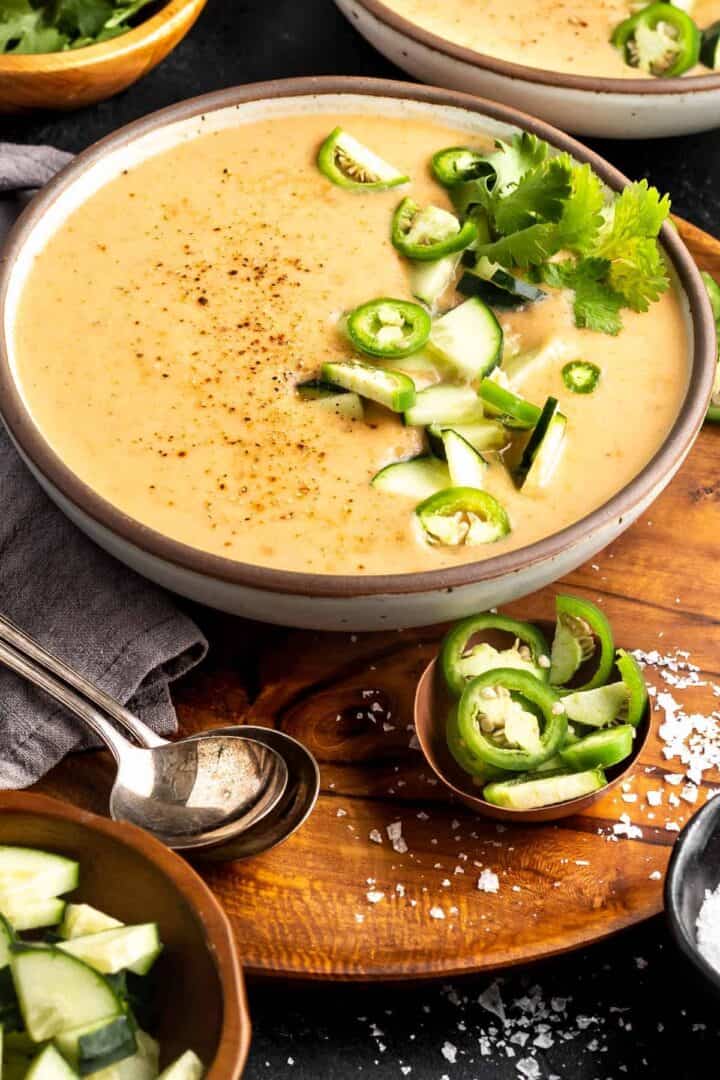 Roasted Vegetable Gazpacho in a bowl topped with cucumber, jalapeno, and cilantro
