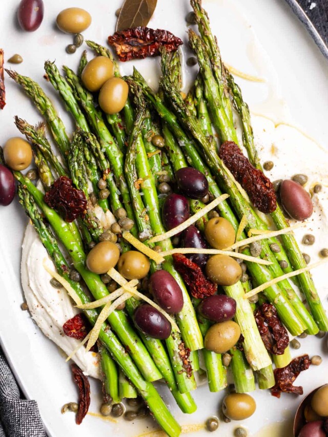 Mediterranean Asparagus - charred lemon garlic asparagus on top of whipped feta and topped with olives, capers, sun-dried tomatoes, and lemon zest.