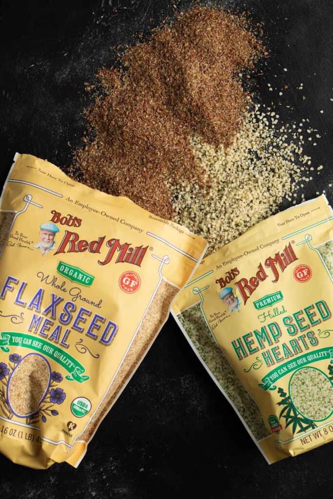 flaxseed and hemp hearts spilled onto a black background