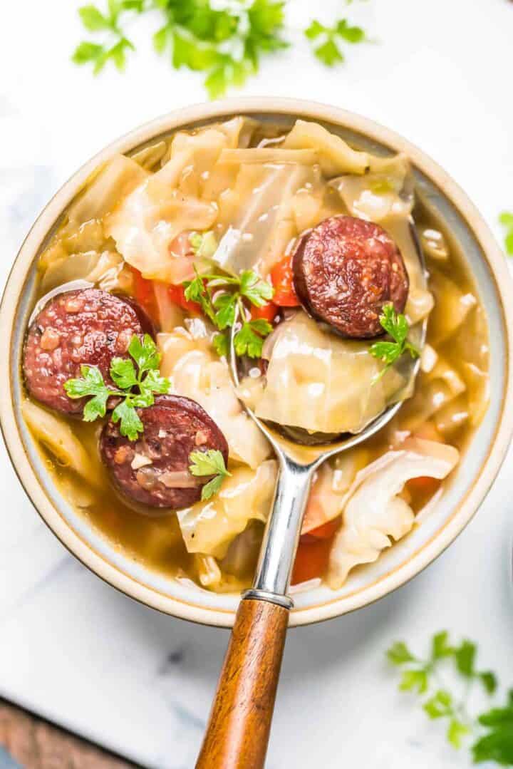 Keto Cabbage Soup close-up in bowl with a spoon in sitting in the bowl