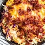 Keto BBQ Chicken Casserole in a cast iron skillet with striped tea towel to the side