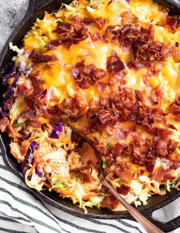 Keto BBQ Chicken Casserole in a cast iron skillet with striped tea towel to the side