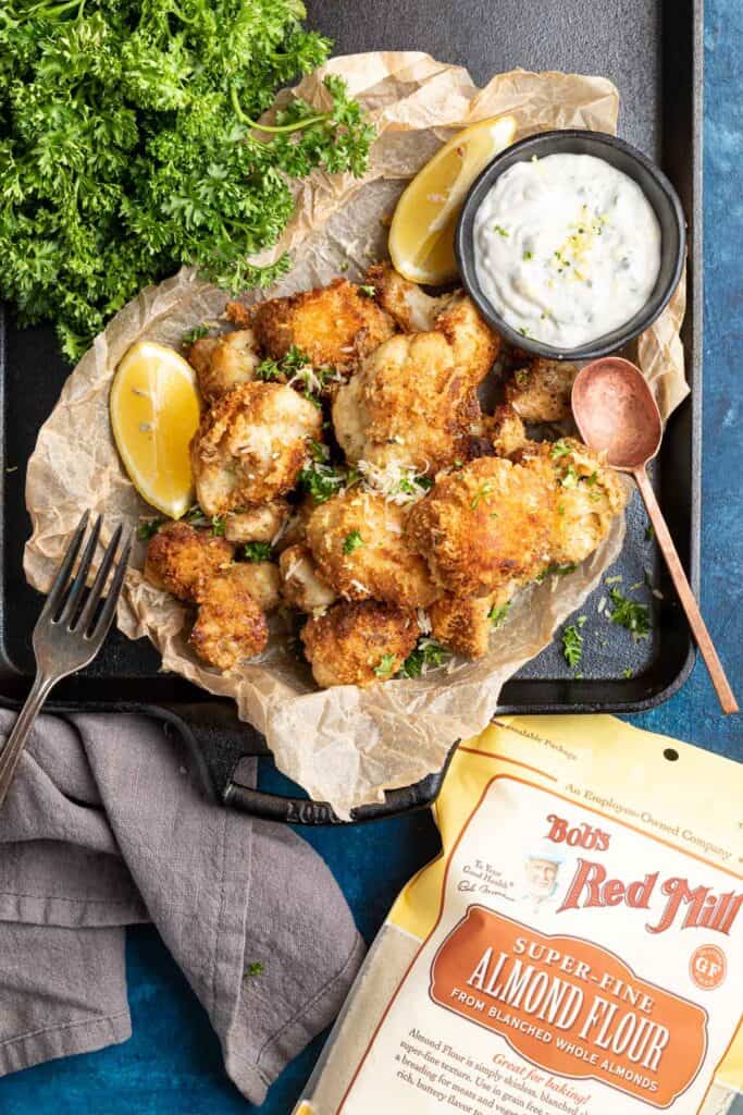 Keto Italian Cauliflower Poppers on a black cast iron tray