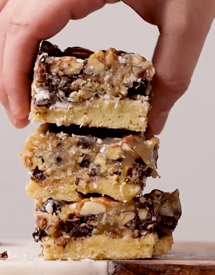 Keto Magic Cookie Bars stacked on top of each other