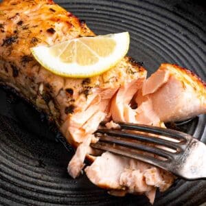 cooked salmon being flaked with fork