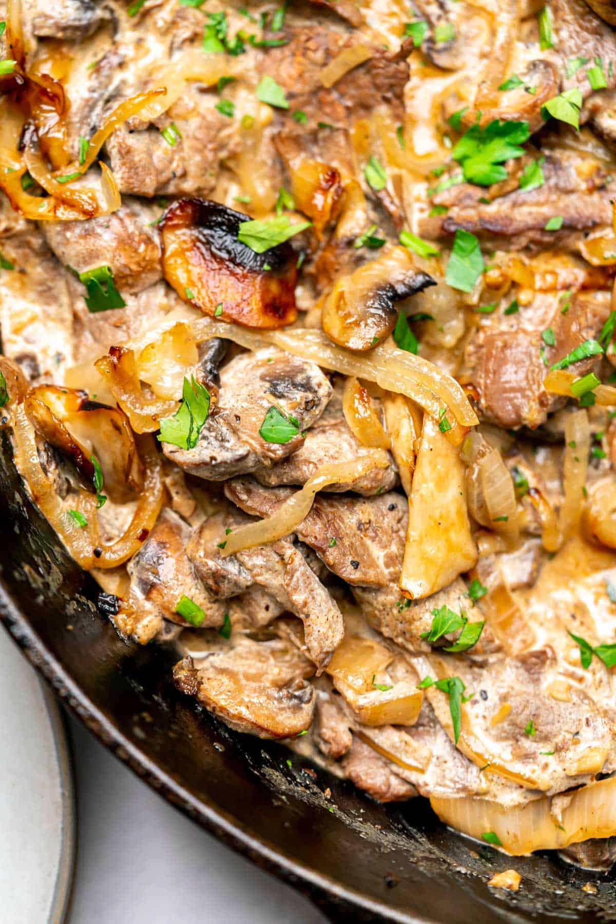 closeup image of beef stroganoff in a cast iron skillet