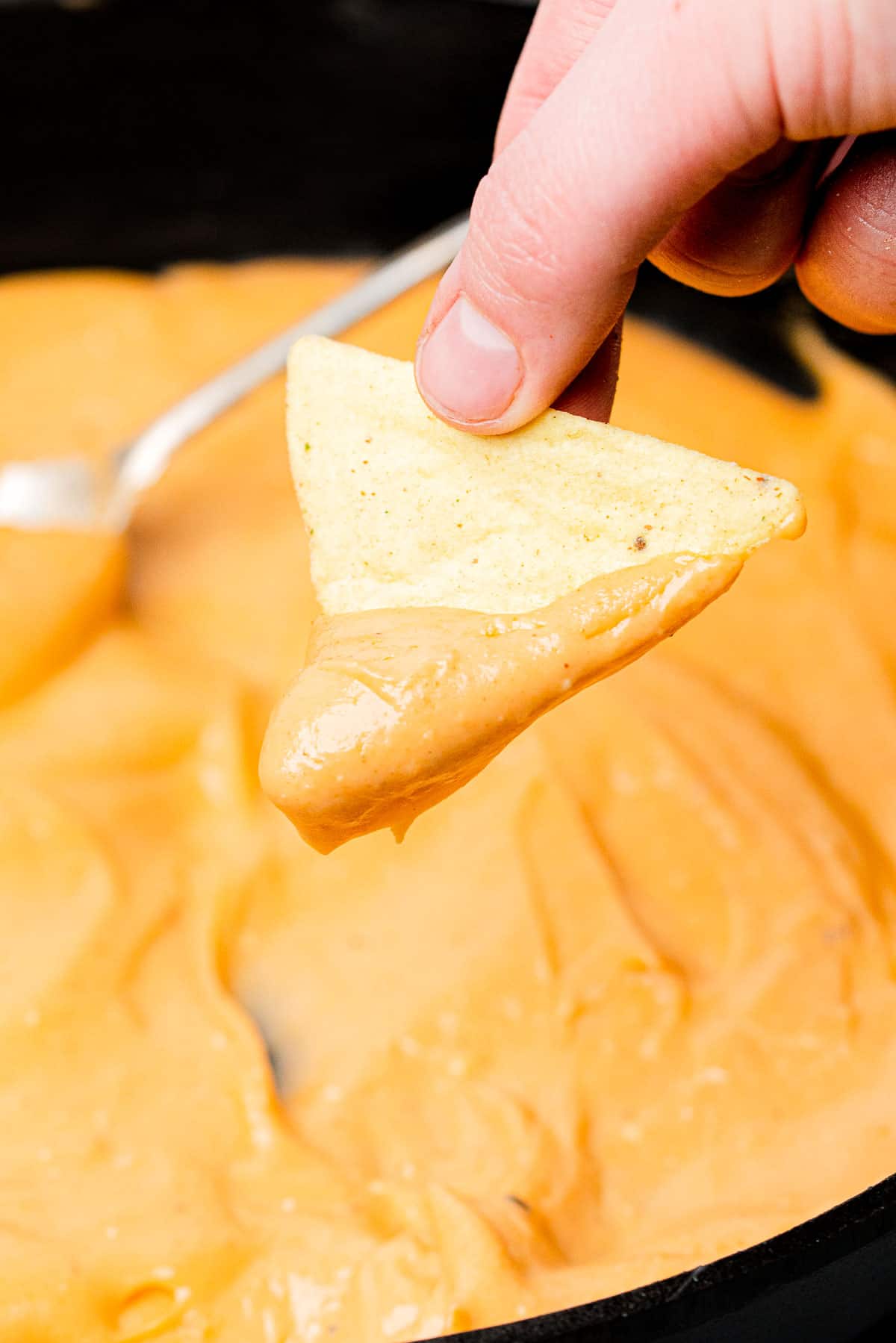 cheese sauce on a tortilla chip