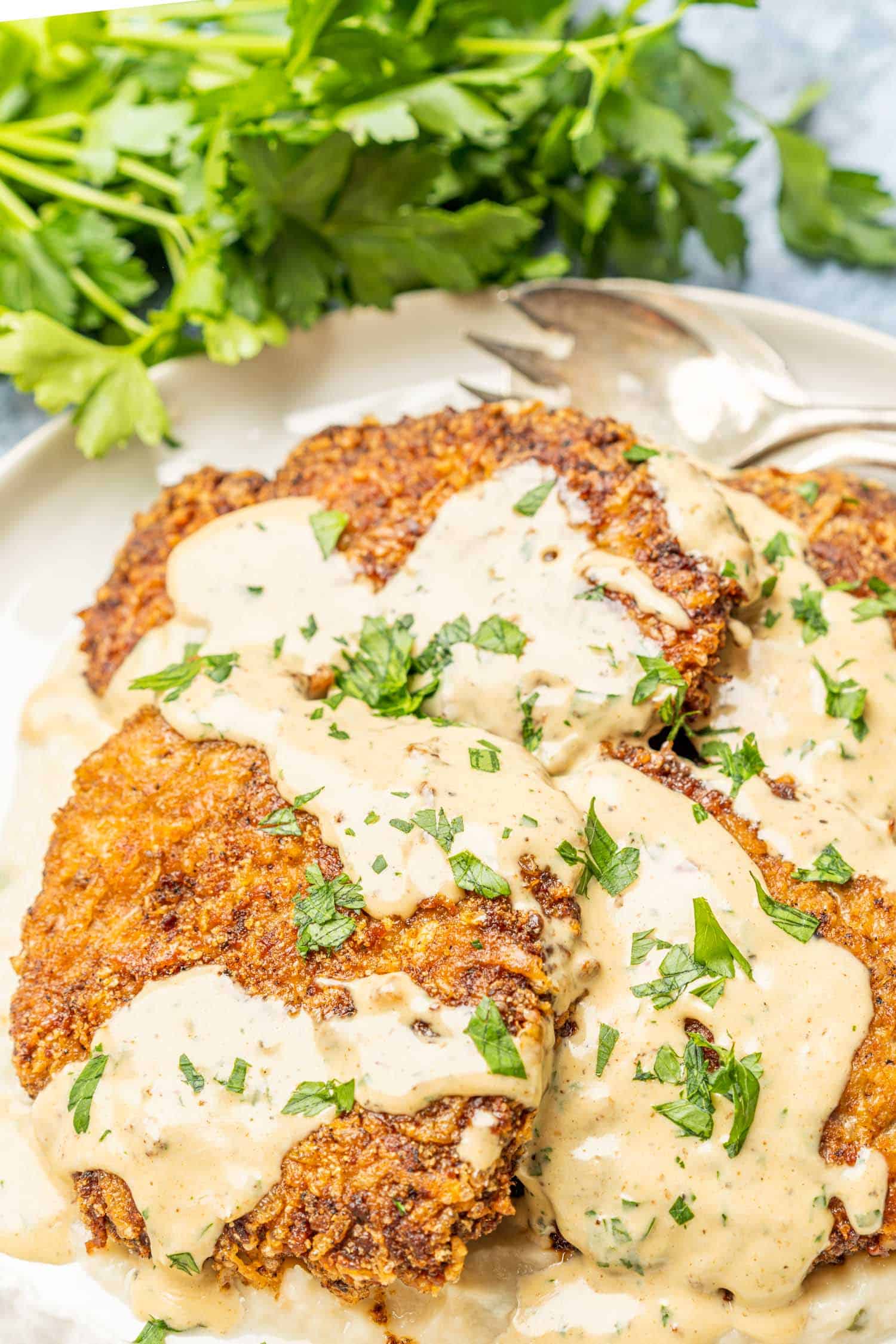 Keto Chicken Fried Steak on platter with parsley in the background