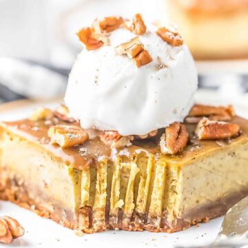 Pumpkin Cheesecake Bar on a plate topped with a scoop of vanilla ice cream