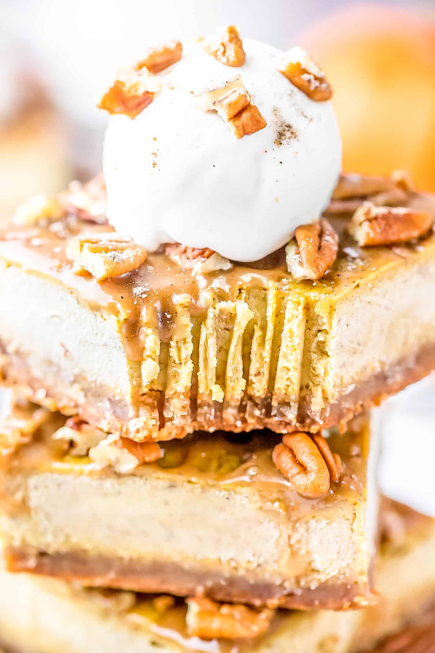 Pumpkin Cheesecake Bar on a plate topped with a scoop of vanilla ice cream